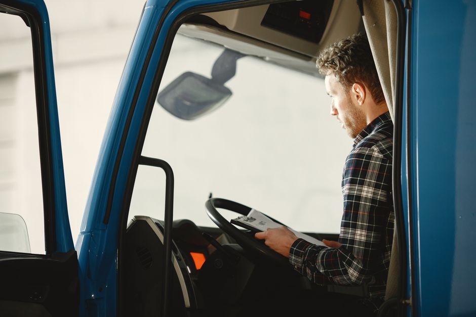 Auto transport driver reviewing shipment paperwork