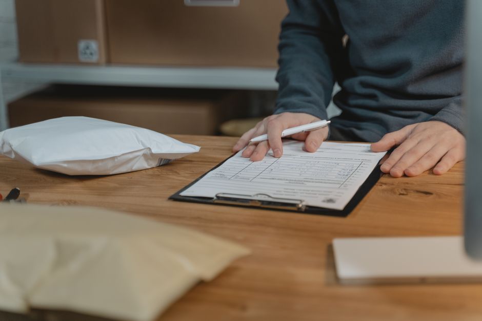 A person filling out a form on a clipboard