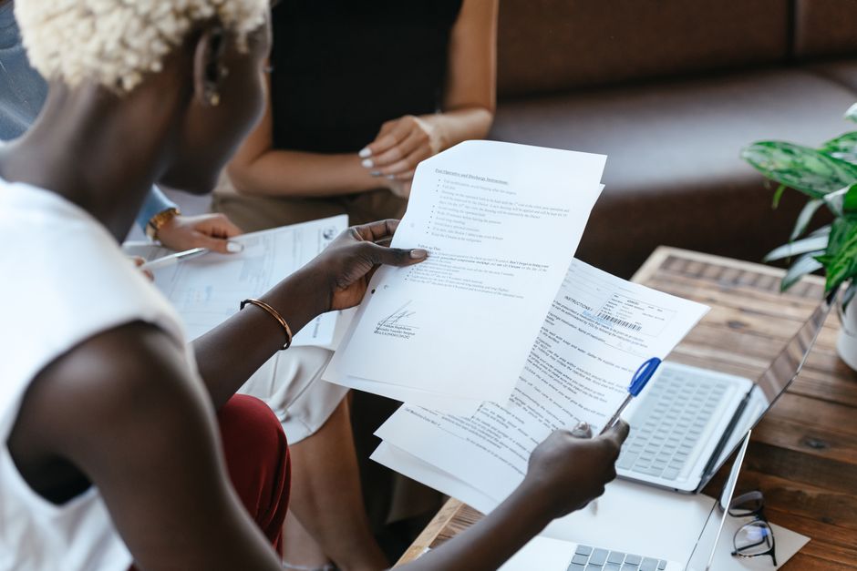 A person reviewing printed quote documents