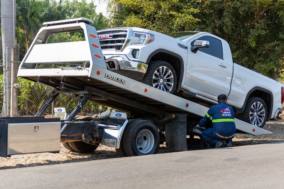 Vehicle being loaded onto a transport truck