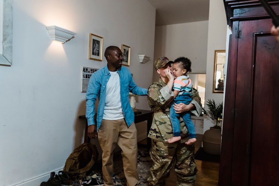 Military service member reuniting with family at home
