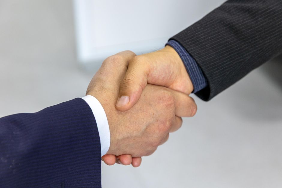 Two professionals shaking hands over an agreement