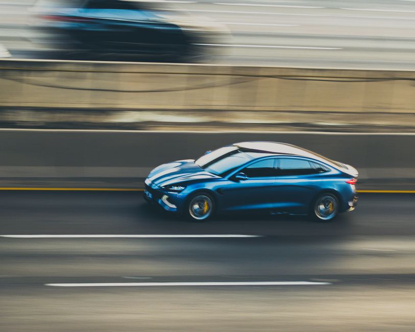 A car in motion on the highway, conveying speed